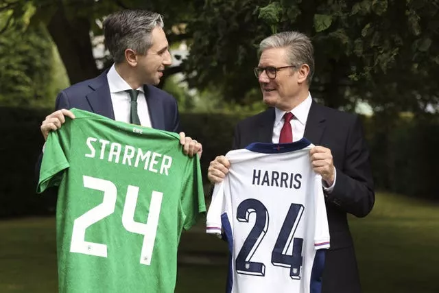 British Prime Minister Sir Keir Starmer, right, and Taoiseach Simon Harris exchange Republic of Ireland and England football shirts with each other's surname on and the number 24