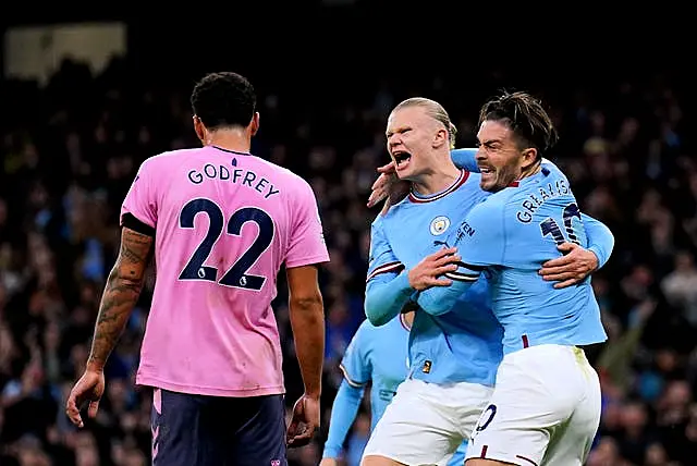 Erling Haaland celebrates with Jack Grealish