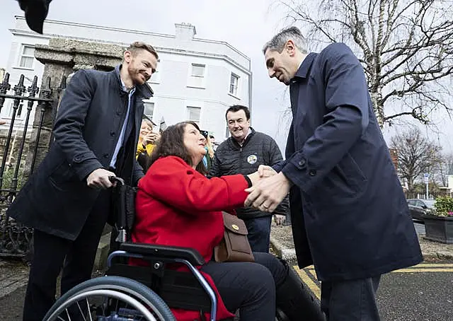 Simon Harris with a woman in a wheelchair