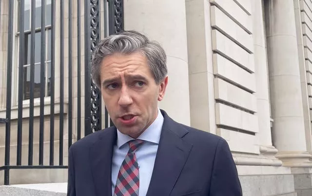 Taoiseach Simon Harris outside building