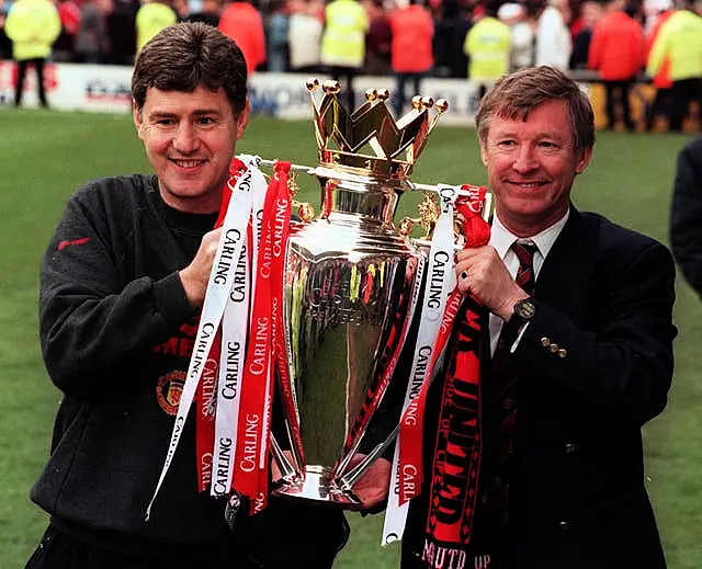 Manchester United manager Alex Ferguson (right) and assistant manager Brian Kidd holding aloft the Premiership trophy after beating Middlesbrough at the Riverside Stadium