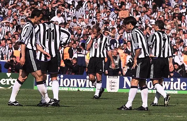 Newcastle's Alan Shearer (centre) looks dejected, following the 2-0 FA Cup final defeat by Manchester United