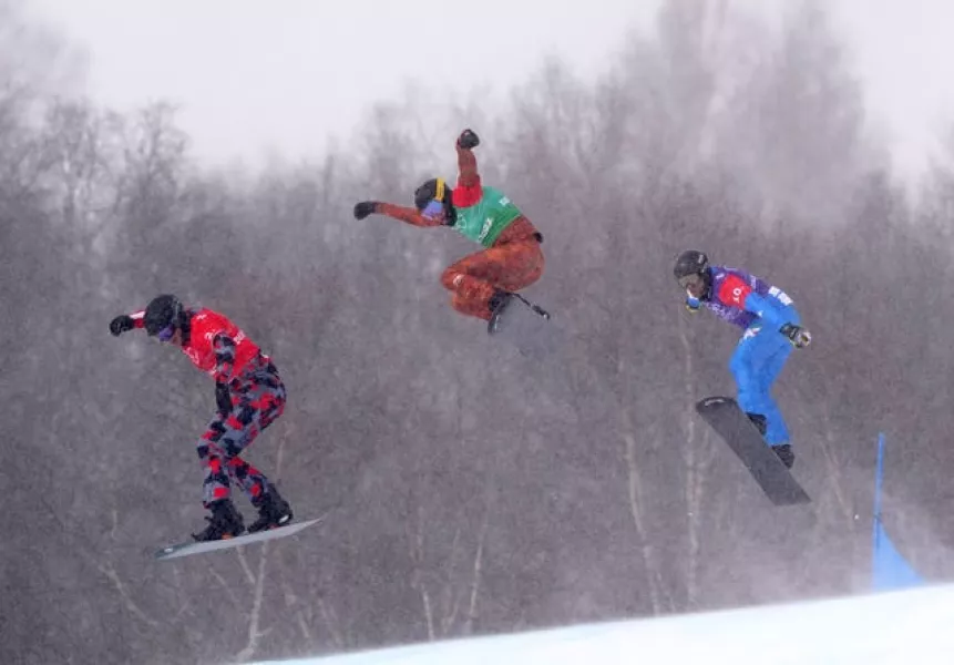 Austria’s Pia Zerkhold, Canada’s Tess Critchlow and Italy’s Caterina Carpano (left-right) competing in the mixed team snowboard cross 