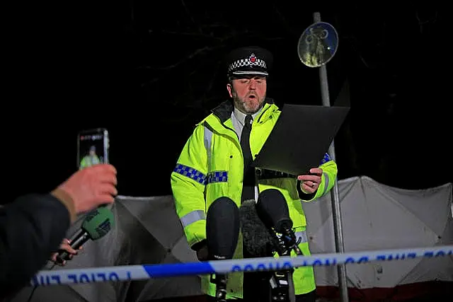 Chief Superintendent Neil Blackwood reads a statement to the media at the scene 