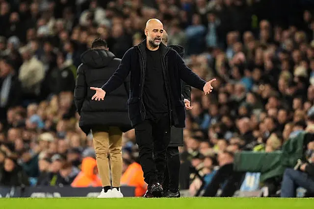 Pep Guardiola holds his arms out in frustration on the touchline