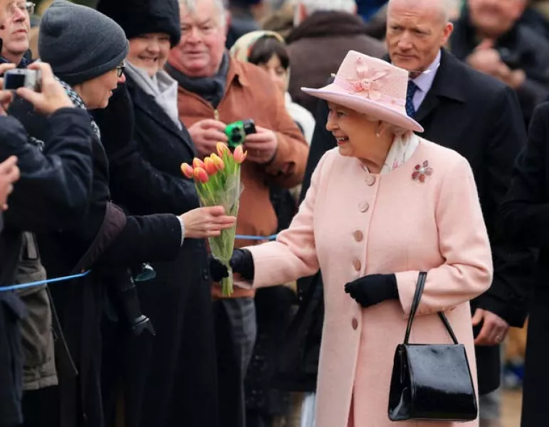 The Queen receives flowers from well-wishers
