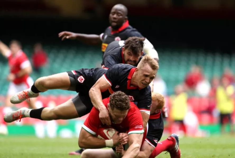 Will Rowlands is tackled by Canada’s Peter Nelson