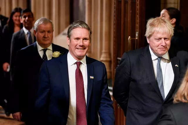 Labour Party leader Sir Keir Starmer and Prime Minister Boris Johnson walk through the Members’ Lobby at the Palace of Westminster ahead of the State Opening of Parliament in the House of Lords
