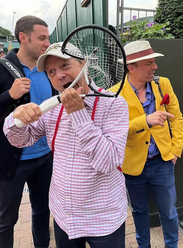 A tennis fan with the broken racket of Novak Djokovic