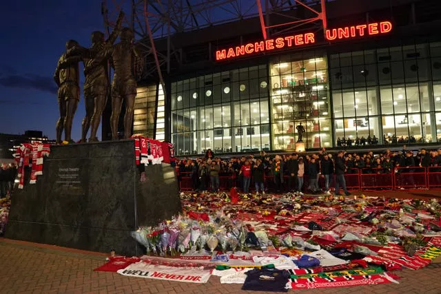 Tributes in memory of Sir Bobby Charlton have been laid outside Old Trafford