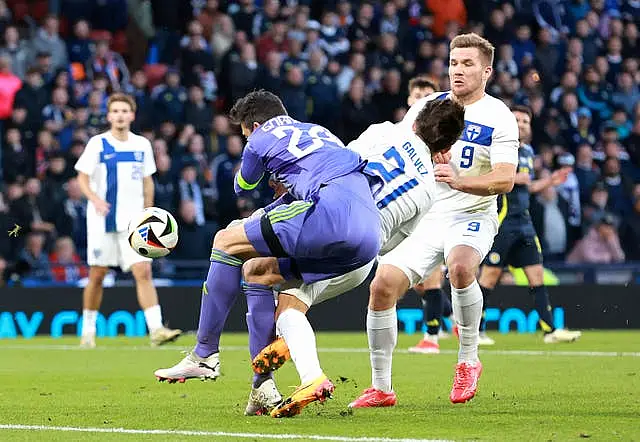 Craig Gordon, left, collides with Finland’s Tomas Galvez to concede a late penalty