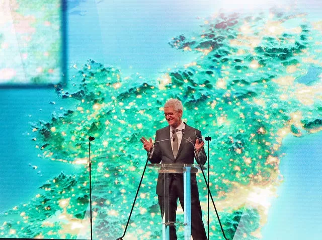 Tim Cook speaking on a stage with a map of Ireland behind him