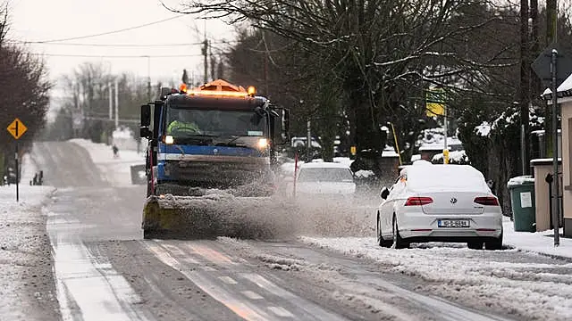 A snow plough and gritting lorry