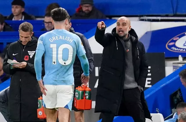 Manchester City manager Pep Guardiola with Jack Grealish on the touchline