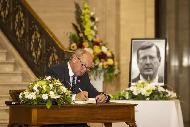 Jim Allister signing a book of condolence