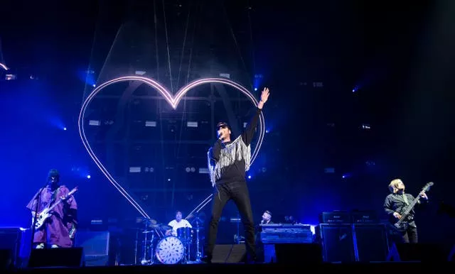 Kasabian performing on stage during the Isle of Wight Festival