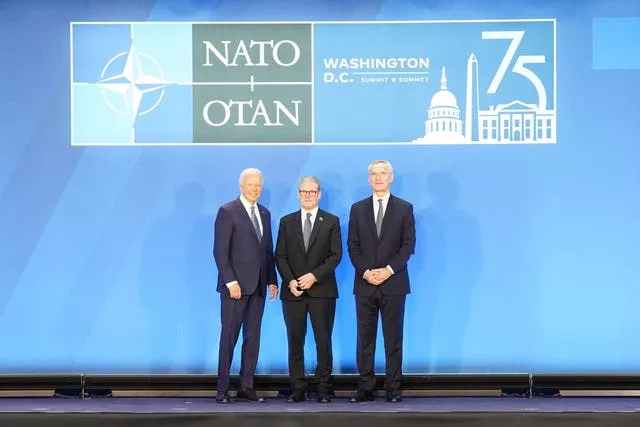 Joe Biden, left, posing for photos with Sir Keir Starmer, centre, and Jens Stoltenberg