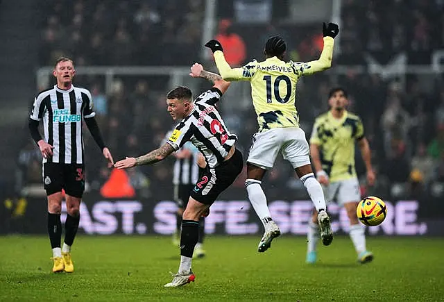 Kieran Trippier and and Crysencio Summerville battle for the ball 