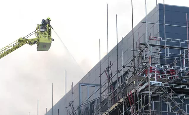 Firefighters at the scene after a blaze at a block of flats on Freshwater Road in Dagenham, East London.