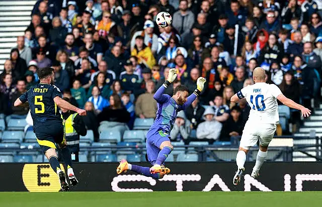 Finland’s Teemu Pukki, right, attempts to chip Scotland goalkeeper Angus Gunn, centre