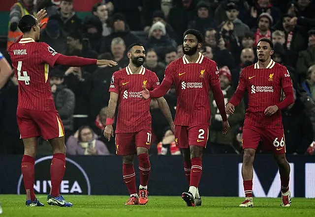 Mohamed Salah, second left, celebrates with, from left, Virgil van Dijk, Joe Gomez and Trent Alexander-Arnold after scoring Liverpool’s third goal against Leicester