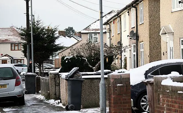 A police officer outside an address in Cornwallis Road, Dagenham