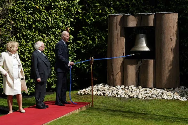 Irish President Michael D Higgins and his wife Sabina watch as US President Joe Biden rings the Peace Bell at Aras an Uachtarain, in Phoenix Park, Dublin