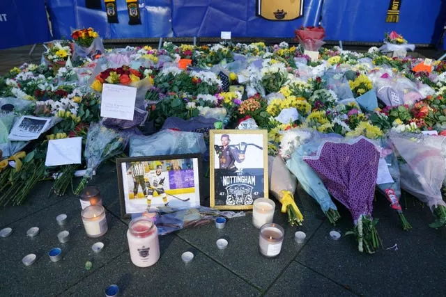 Lit candles among the flowers and messages left in tribute to Nottingham Panthers player Adam Johnson outside the Motorpoint Arena in Nottingham