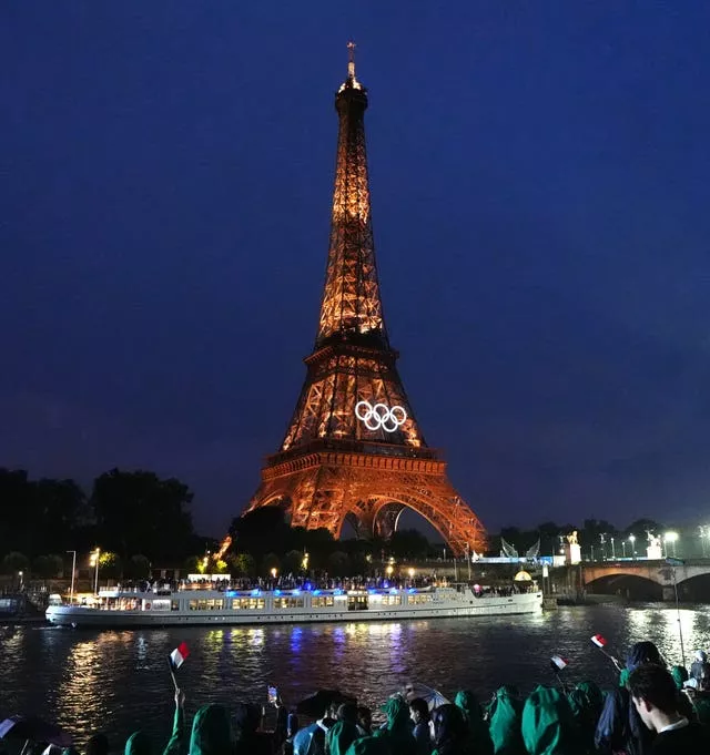 The France team travel by boat down the Seine past the Eiffel Tower