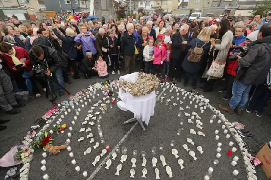 People gather to protest at the site of the former Tuam home, where a mass grave of around 800 babies was uncovered 