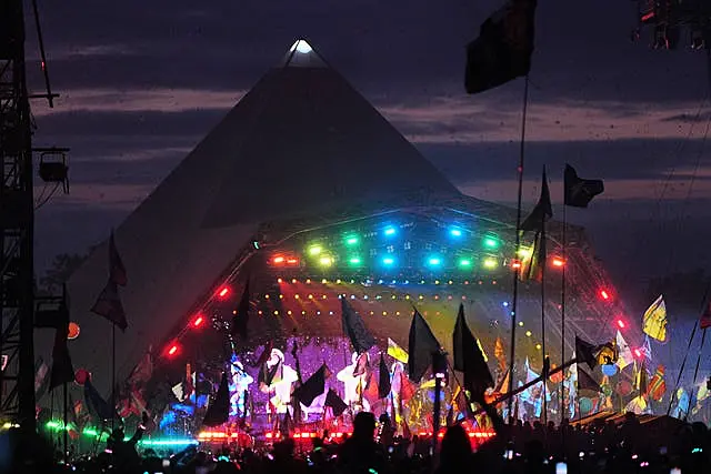 The crowd watching Coldplay performing on the Pyramid Stage at Glastonbury Festival