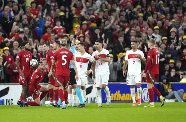 Turkey's Baris Alper Yilmaz, back, is sent off against Wales