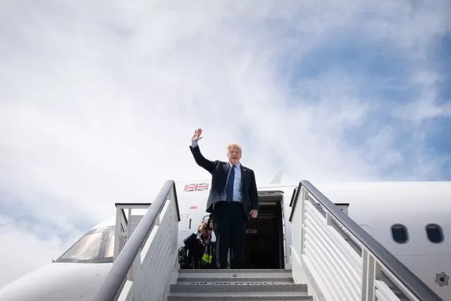 Prime Minister Boris Johnson boarding a plane as he leaves the Nato summit in Madrid