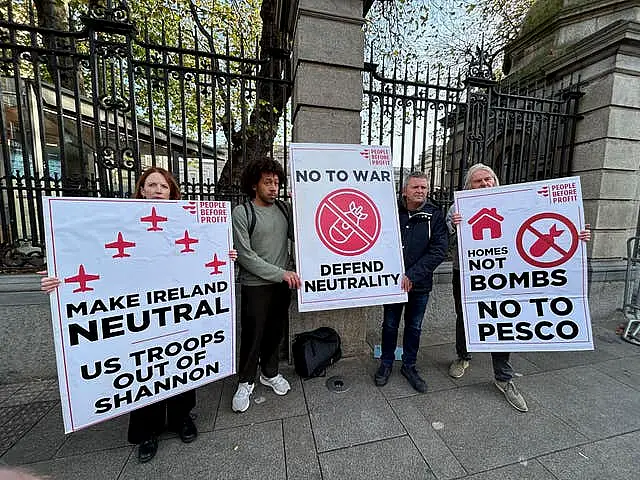 Richard Boyd Barrett holding a sign reading 'NO TO WAR' with other people