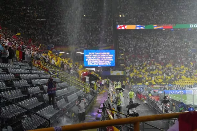 A message on a big screen at the stadium tells fans the match has been suspended