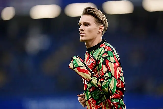 Arsenal captain Martin Odegaard warms up ahead of the match against Chelsea