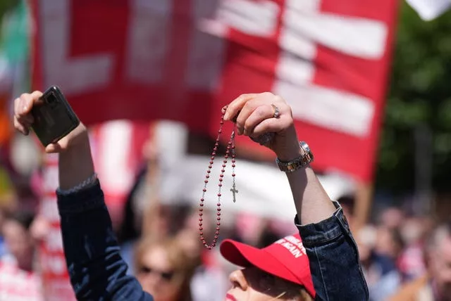 An anti-abortion demonstrator holds up rosary beads during a Rally for Life march on O’Connell Street in Dublin