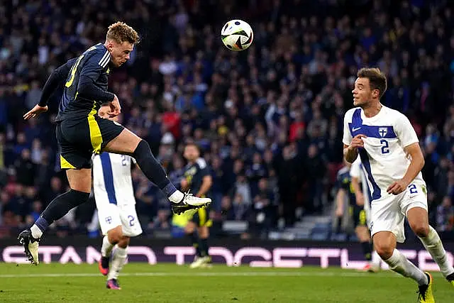 Scotland's Tommy Conway, left, heads at goal against Finland