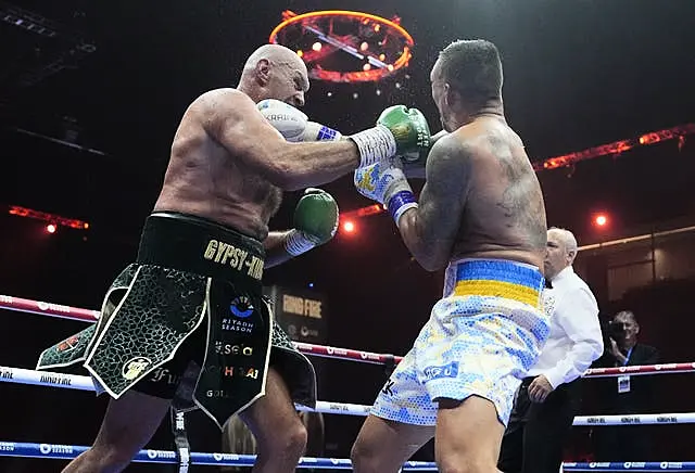 Tyson Fury and Oleksandr Usyk both throw punches