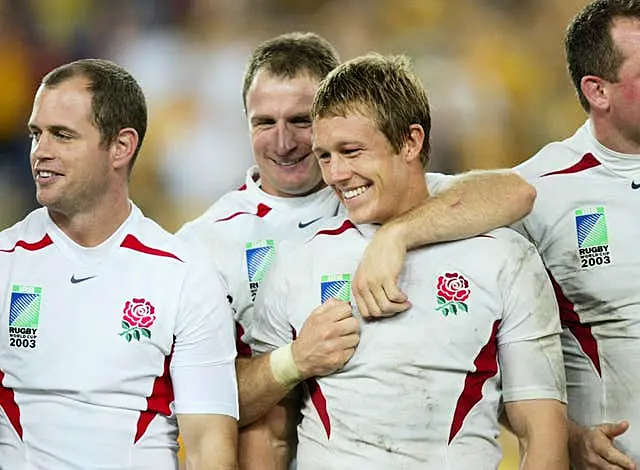 Jonny Wilkinson (centre right) is congratulated by team-mate Mike Catt after his drop goal clinched the 2003 Rugby World Cup 