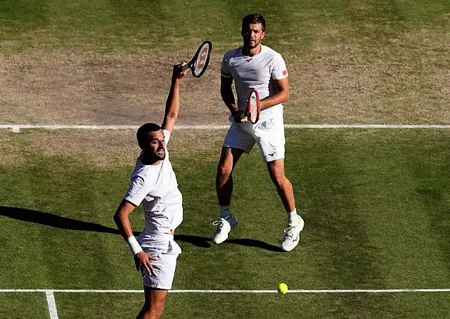 Mate Pavic (left) played in the final with a broken right wrist