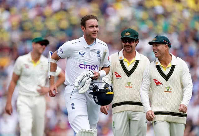 David Warner, right, and Travis Head share a joke with Stuart Broad, left, as he leaves the field after batting