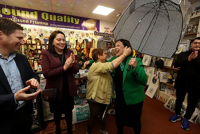 Helen Drumm gifting Mary Lou McDonald an umbrella