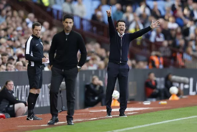 Aston Villa manager Unai Emery, right, shouts instructions as Arsenal manager Mikel Arteta watches on