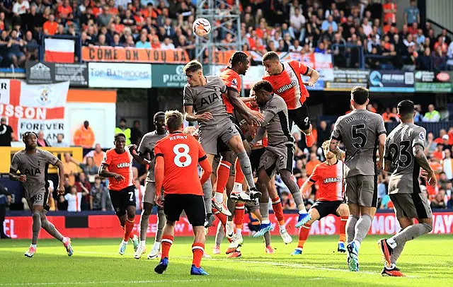 Carlton Morris, centre right, attempts a header against Spurs 