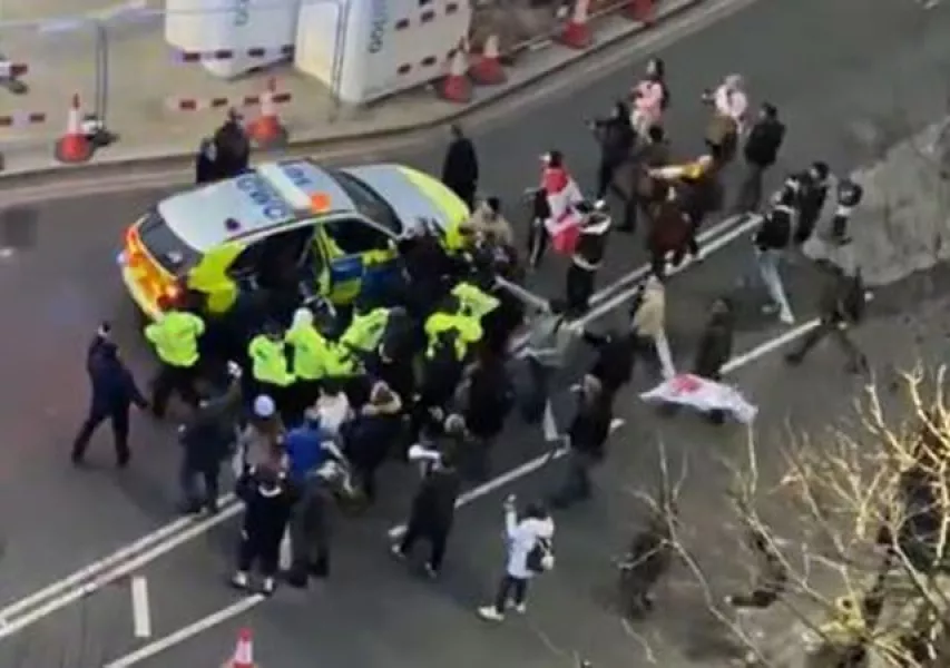 Police and protesters clash in Westminster as officers use a police vehicle to escort Sir Keir Starmer to safety