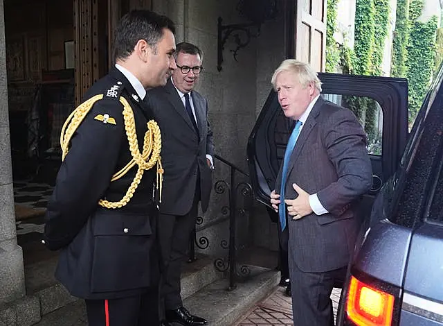 Boris Johnson is greeted by the then Queen Elizabeth II’s Equerry Lieutenant Colonel Tom White and her private Secretary Sir Edward Young as he arrives at Balmoral for an audience to formally resign (Andrew Milligan/PA)