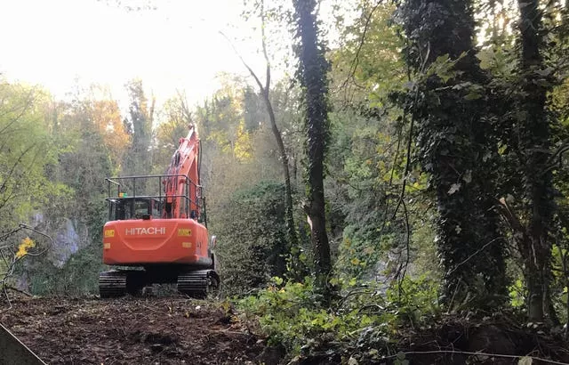 An excavator at a flooded quarry