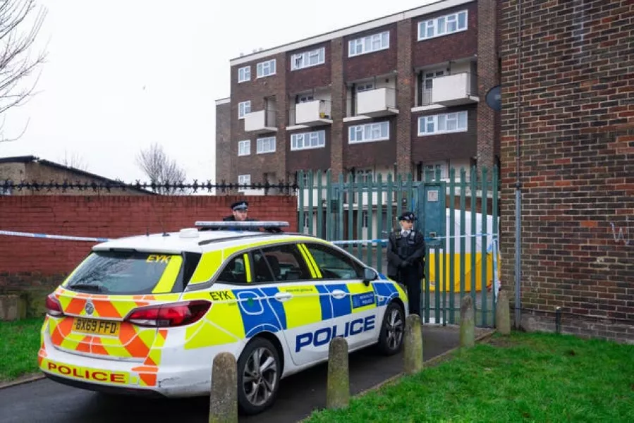 Police officers at the scene of a fatal stabbing at flats on Wisbeach Road in Croydon