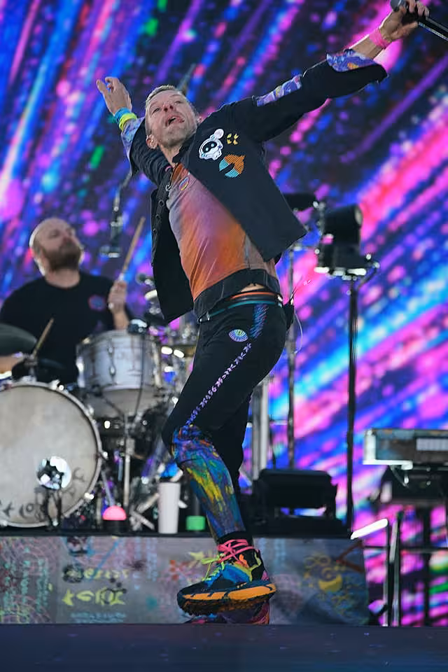 Coldplay singer Chris Martin dancing on stage